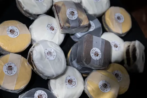 Alfajores envueltos en papel con la etiqueta de un emprendimiento, apilados en una bandeja, Copa Cata del Oeste 2022